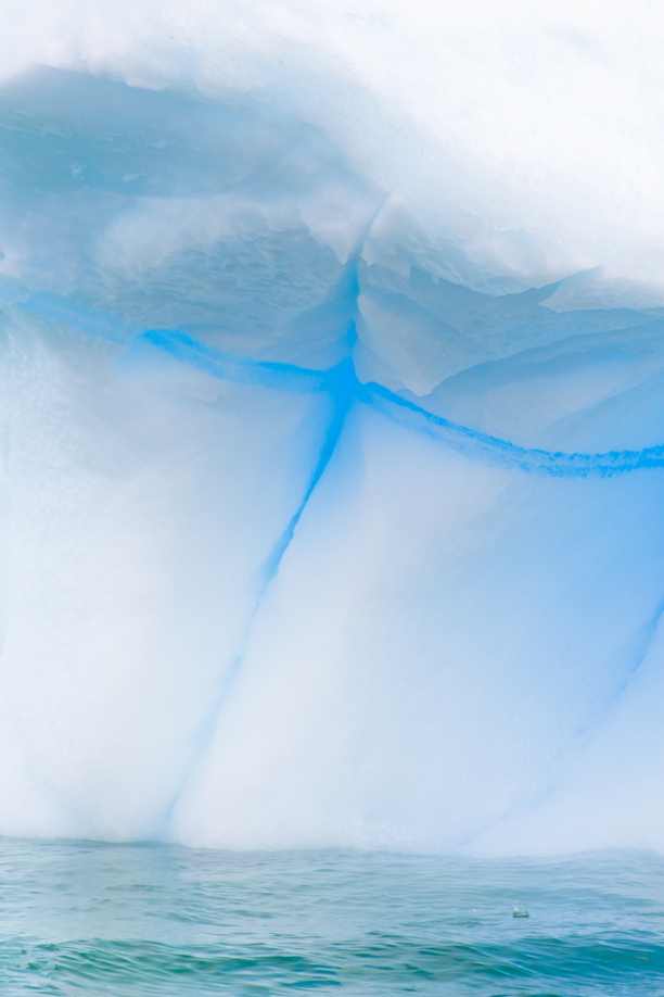 Greenland’s icebergs are immense. Up to 200 feet in height, and numerous in volume. I took to the fjord in in a zodiac eager to explore further. Here I stumbled across this ice monument and was immediately enraptured by its texture, contrast and intense colour. I waited until the clouds framed the iceberg in an ethereal way and took the opportunity to capture my favourite imageNotes: Handheld on an zodiac cruise